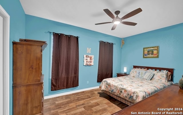 bedroom featuring hardwood / wood-style flooring and ceiling fan