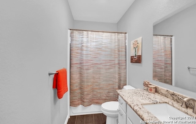 full bathroom with wood-type flooring, vanity, toilet, and shower / bathtub combination with curtain