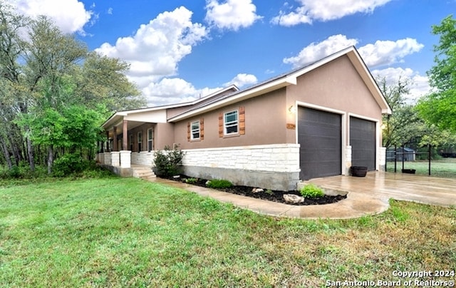 view of property exterior with a garage and a yard