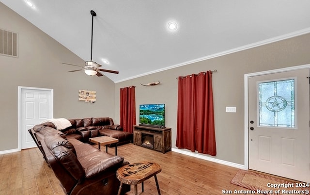 living room with ceiling fan, lofted ceiling, ornamental molding, and light hardwood / wood-style flooring