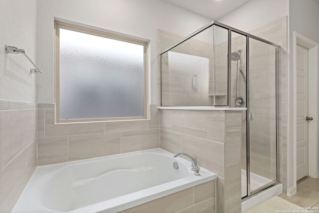 bathroom featuring tile patterned flooring and independent shower and bath