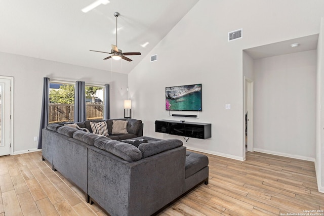 living room featuring high vaulted ceiling, light hardwood / wood-style floors, and ceiling fan