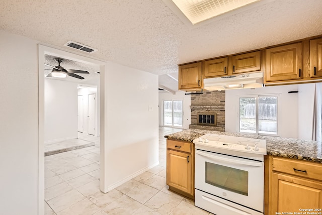 kitchen with ceiling fan, plenty of natural light, a textured ceiling, and white electric stove