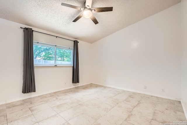 unfurnished room with a textured ceiling, ceiling fan, and lofted ceiling