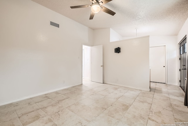 unfurnished room featuring a textured ceiling, high vaulted ceiling, and ceiling fan