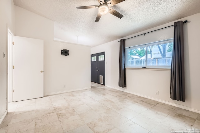 spare room featuring ceiling fan and a textured ceiling