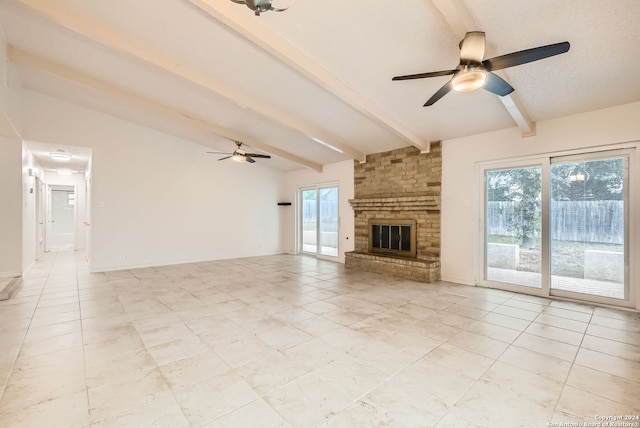 unfurnished living room featuring vaulted ceiling with beams, a brick fireplace, and ceiling fan