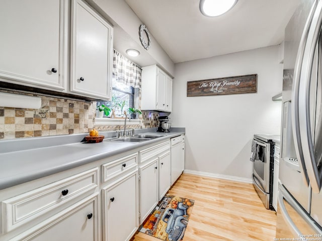 kitchen with light wood-type flooring, tasteful backsplash, white cabinetry, and stainless steel appliances