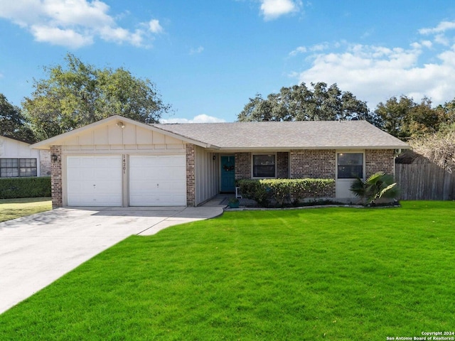 single story home featuring a garage and a front lawn