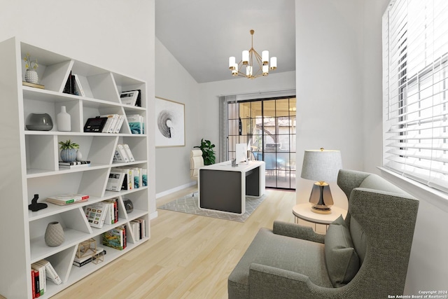 sitting room with lofted ceiling, light hardwood / wood-style floors, and a notable chandelier