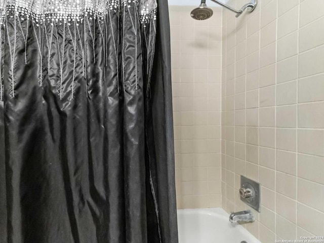 bathroom featuring shower / bath combo with shower curtain