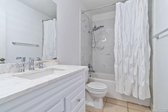 full bathroom featuring tile patterned floors, vanity, toilet, and shower / tub combo with curtain