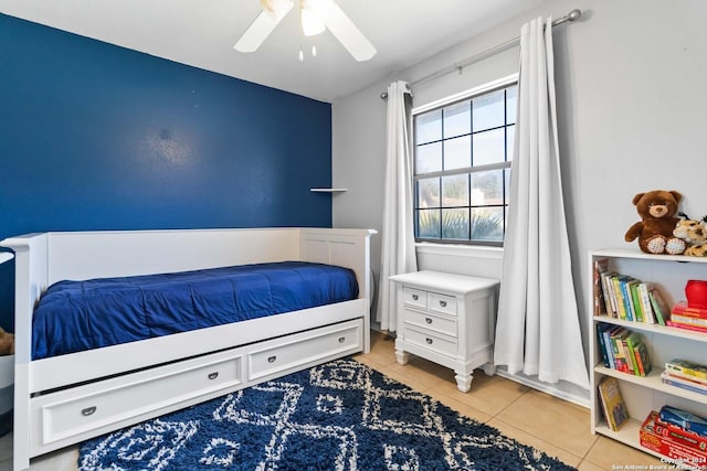 tiled bedroom featuring ceiling fan