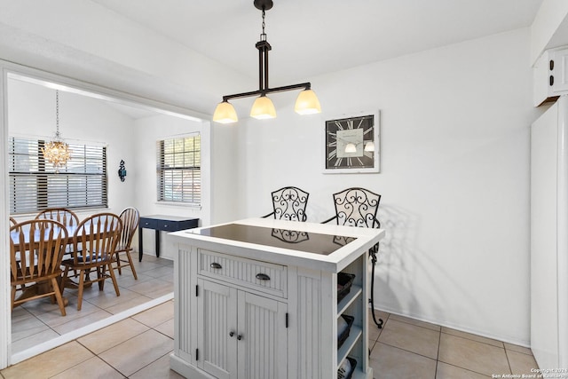 kitchen with gray cabinets, decorative light fixtures, light tile patterned flooring, and a notable chandelier