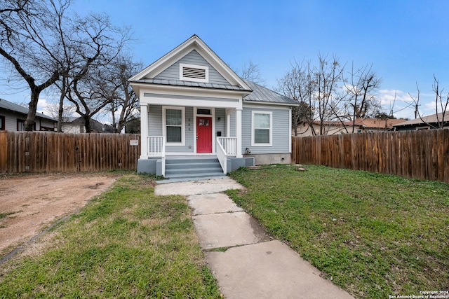 bungalow-style house featuring a front yard