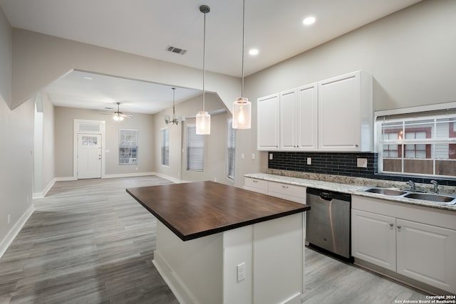 kitchen with dishwasher, light wood-type flooring, butcher block countertops, and white cabinetry