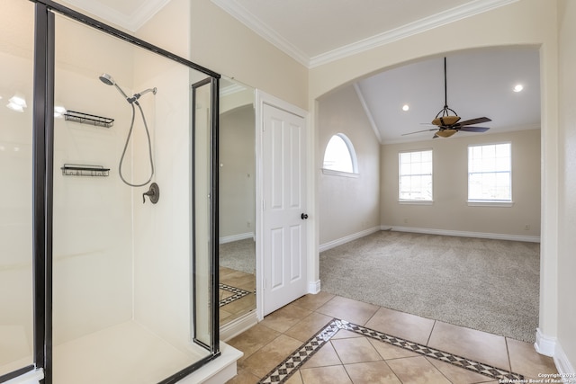 bathroom featuring tile patterned flooring, ceiling fan, crown molding, and a shower with shower door