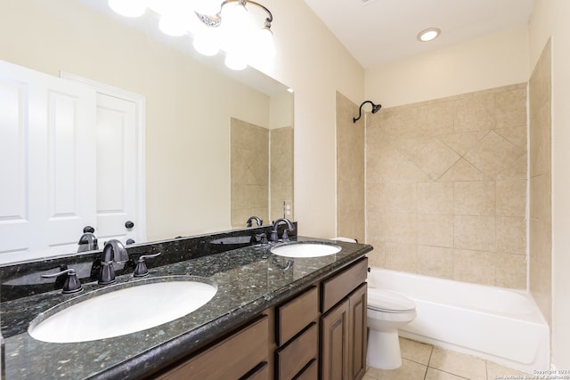 full bathroom featuring toilet, vanity, tiled shower / bath combo, and tile patterned floors