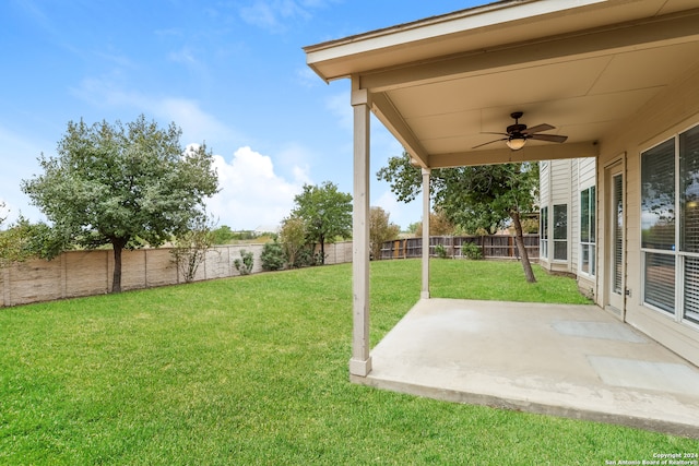 view of yard with ceiling fan and a patio