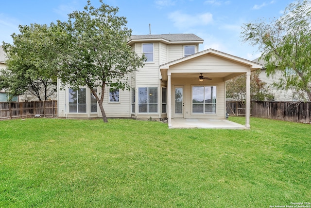 back of house with a patio area, a yard, and ceiling fan