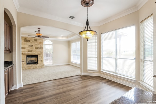 unfurnished living room featuring ornamental molding, dark hardwood / wood-style floors, and ceiling fan