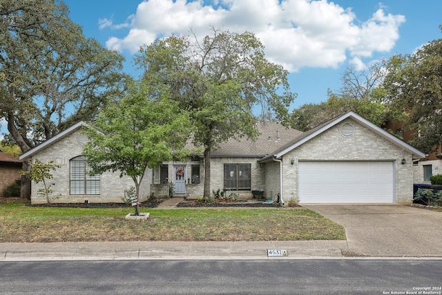 view of front of property featuring a garage and a front yard