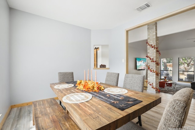 dining space with hardwood / wood-style floors