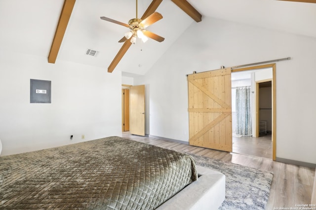 bedroom with wood-type flooring, a barn door, high vaulted ceiling, ceiling fan, and beam ceiling