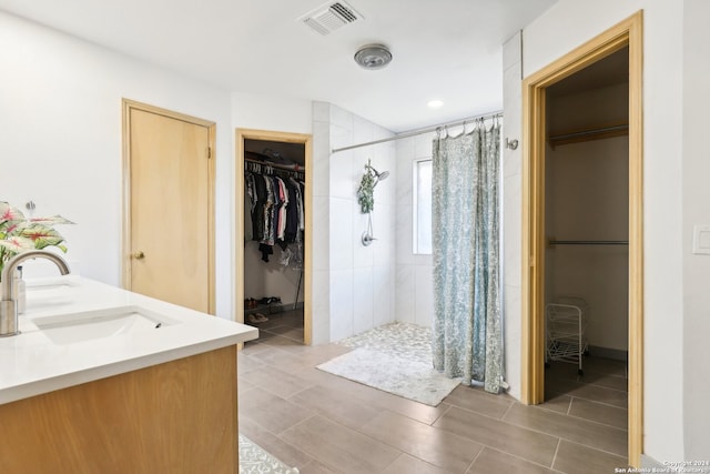 bathroom with walk in shower and vanity