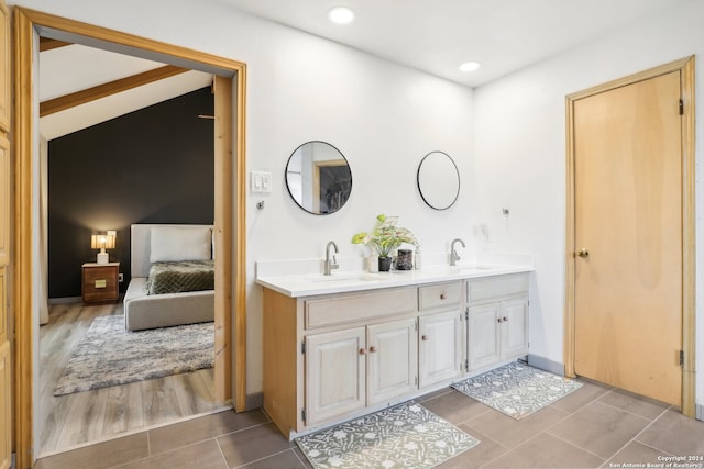 bathroom with lofted ceiling with beams, vanity, and hardwood / wood-style flooring