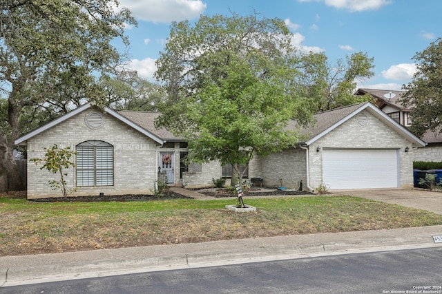 view of front of property featuring a garage and a front yard