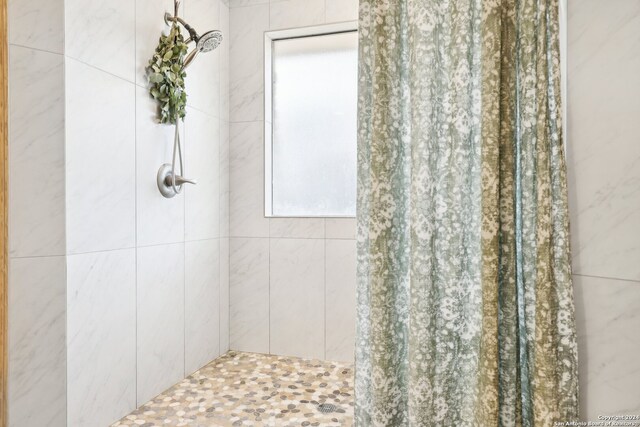 bathroom with tiled shower