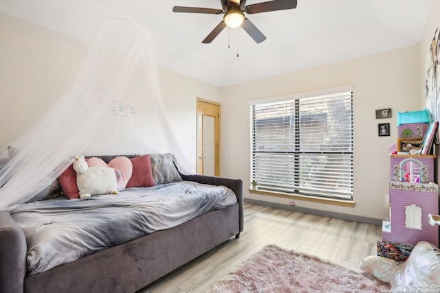 bedroom with ceiling fan and light wood-type flooring