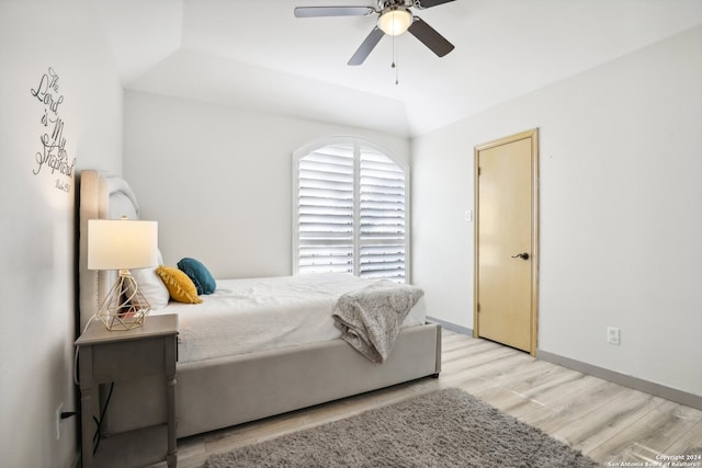 bedroom with lofted ceiling, ceiling fan, and light hardwood / wood-style flooring