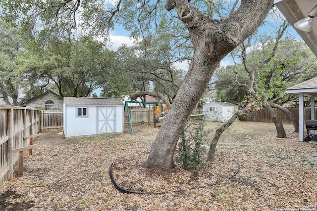 view of yard featuring a playground and a shed