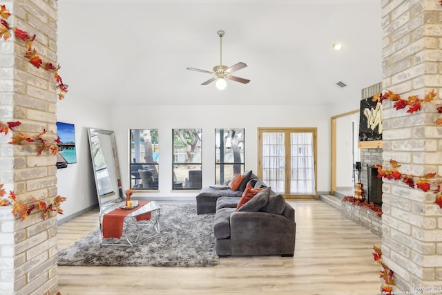 living room with light hardwood / wood-style flooring, ceiling fan, a healthy amount of sunlight, and a fireplace