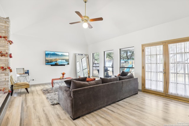 living room featuring french doors, light hardwood / wood-style floors, ceiling fan, and high vaulted ceiling