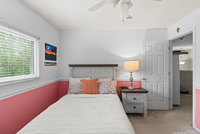 bedroom with light colored carpet and ceiling fan