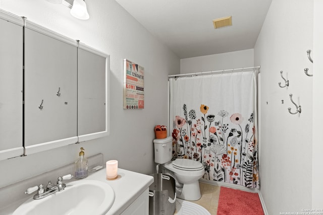 bathroom with curtained shower, vanity, and toilet