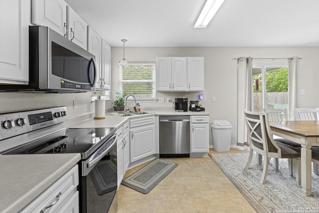 7303 Autumn Flower, Converse, TX 78109 - kitchen with appliances with stainless steel finishes, a sink, plenty of natural light, and white cabinets