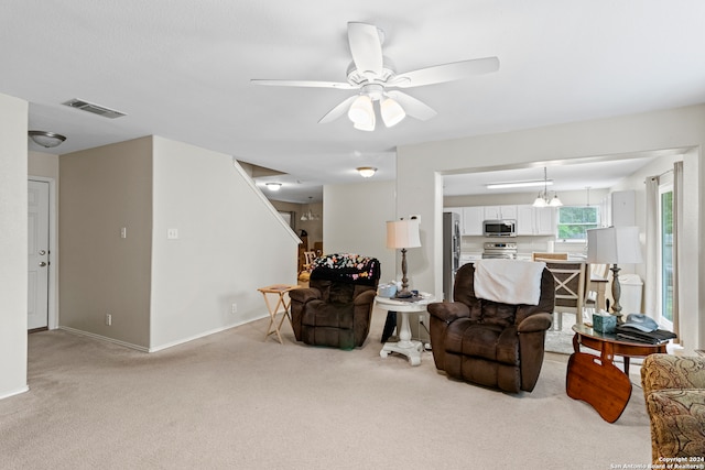 living room with light carpet and ceiling fan