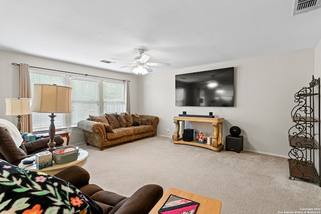 carpeted living room with ceiling fan