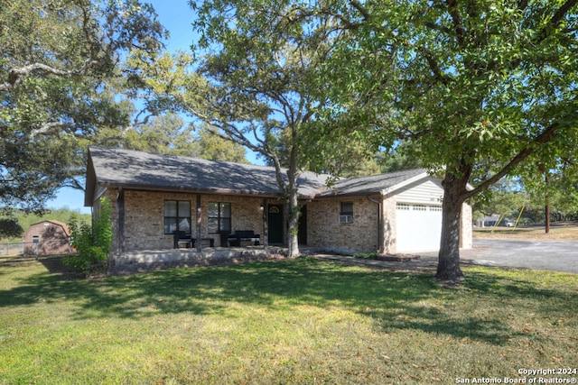 view of front of home featuring a garage, a porch, and a front yard