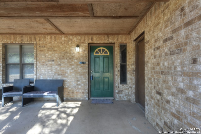 view of exterior entry with a porch