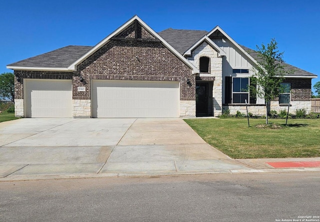 craftsman-style home featuring a garage and a front lawn