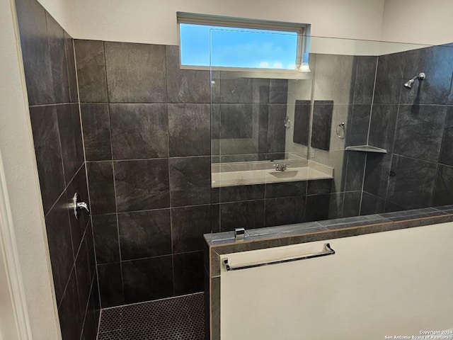 bathroom with a tile shower