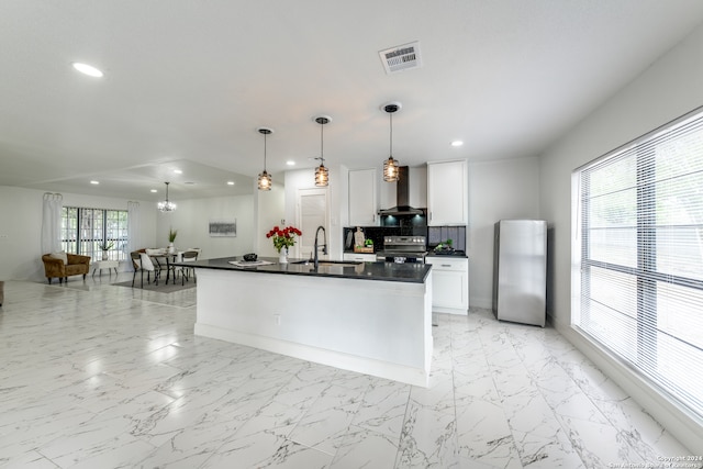 kitchen featuring white cabinets, a wealth of natural light, wall chimney exhaust hood, and stainless steel appliances