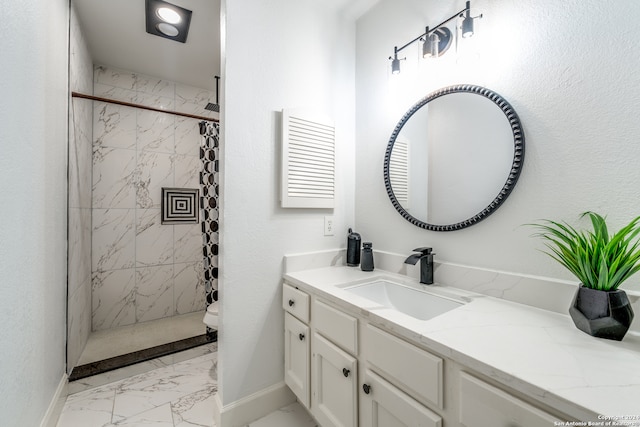 bathroom with toilet, vanity, and tiled shower