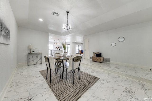 dining space featuring an inviting chandelier