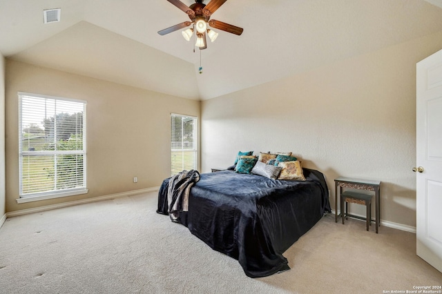 carpeted bedroom featuring vaulted ceiling and ceiling fan